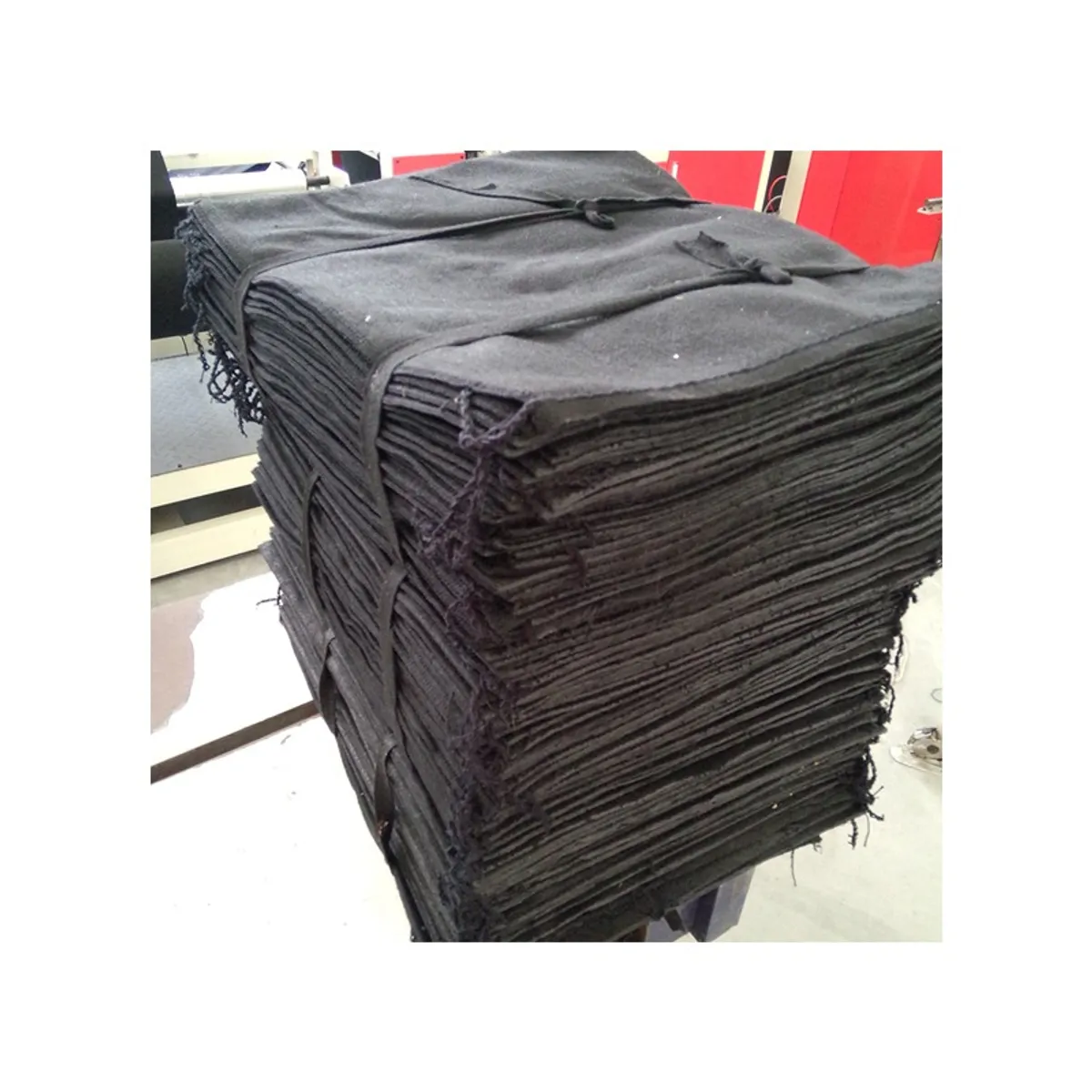 Bundle of sewn black geotextile geobags strapped for shipment